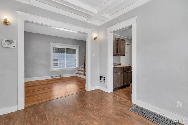 401 Estelle Ave, Ferguson, MO 63135 - empty room featuring wood finished floors, beam ceiling, stairs, and coffered ceiling