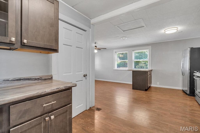 401 Estelle Ave, Ferguson, MO 63135 - kitchen with dark brown cabinetry, wood finished floors, light countertops, and ornamental molding