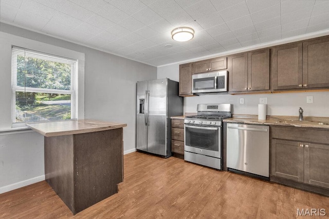 401 Estelle Ave, Ferguson, MO 63135 - kitchen with stainless steel appliances, light wood finished floors, crown molding, and dark brown cabinetry