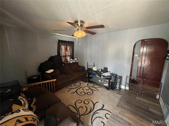 821 Center St, East Alton, IL 62024 - living area with arched walkways, wood finished floors, and ceiling fan