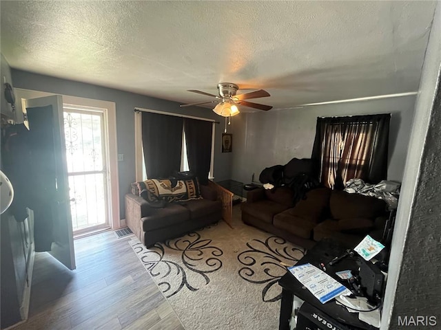 821 Center St, East Alton, IL 62024 - living room with a textured ceiling, wood finished floors, and a ceiling fan