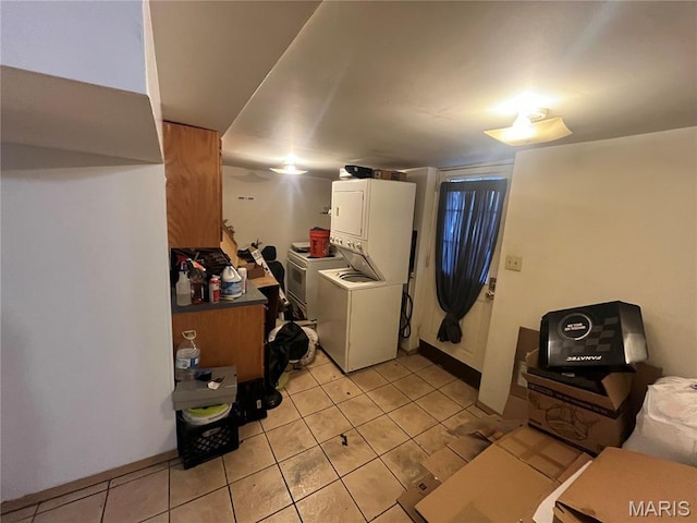 821 Center St, East Alton, IL 62024 - laundry room featuring stacked washer and clothes dryer and light tile patterned flooring