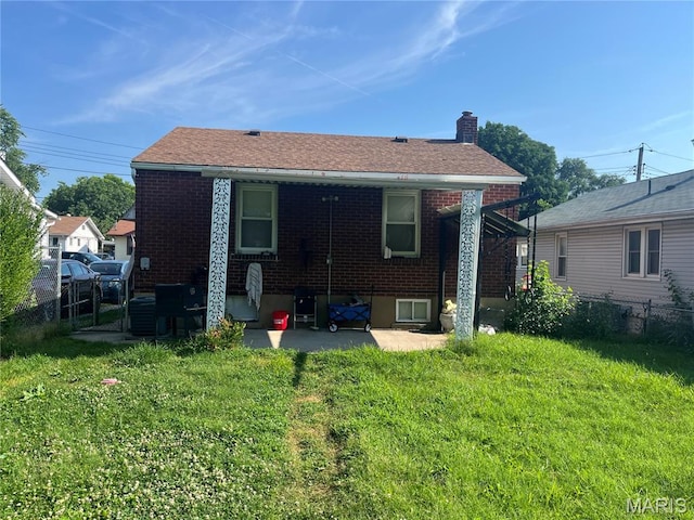 821 Center St, East Alton, IL 62024 - rear view of house featuring brick siding, a patio area, and a chimney