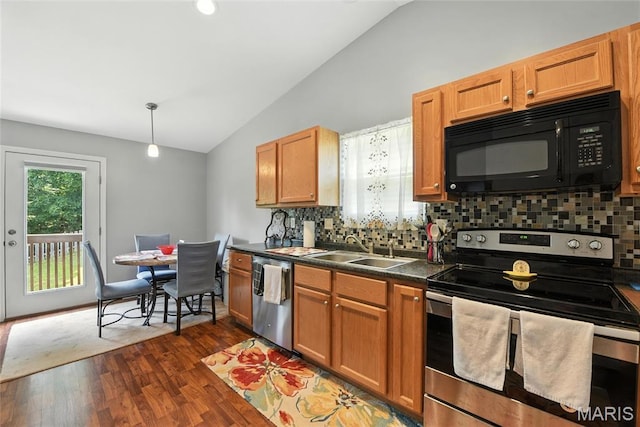2364 Arkansas Dr, High Ridge, MO 63049 - kitchen featuring stainless steel appliances, vaulted ceiling, tasteful backsplash, dark wood finished floors, and dark countertops