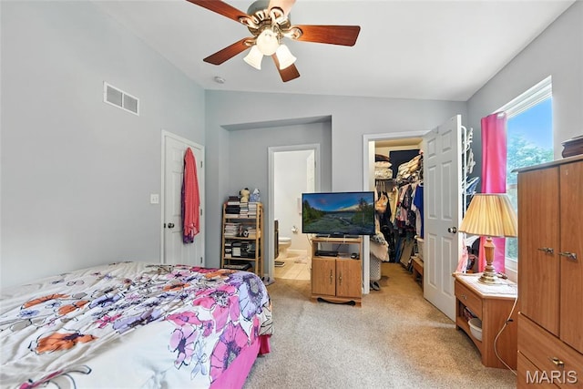 2364 Arkansas Dr, High Ridge, MO 63049 - bedroom with lofted ceiling, a spacious closet, light colored carpet, connected bathroom, and a ceiling fan
