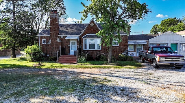 2801 High Ridge Blvd, High Ridge, MO 63049 - tudor home with brick siding, a chimney, a front lawn, and roof with shingles