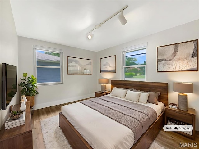 614 Conover Ln, Saint Louis, MO 63126 - bedroom with rail lighting, wood finished floors, and a ceiling fan