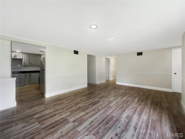 614 Conover Ln, Saint Louis, MO 63126 - unfurnished living room with wood finished floors and recessed lighting