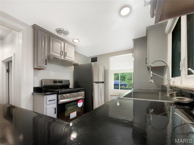 614 Conover Ln, Saint Louis, MO 63126 - kitchen with appliances with stainless steel finishes, under cabinet range hood, dark countertops, and gray cabinetry