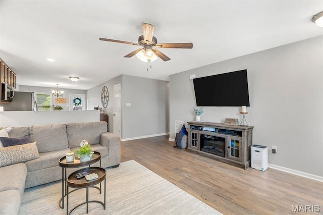 688 Rabbit Run Dr, Wentzville, MO 63385 - living area featuring a chandelier, wood finished floors, and ceiling fan