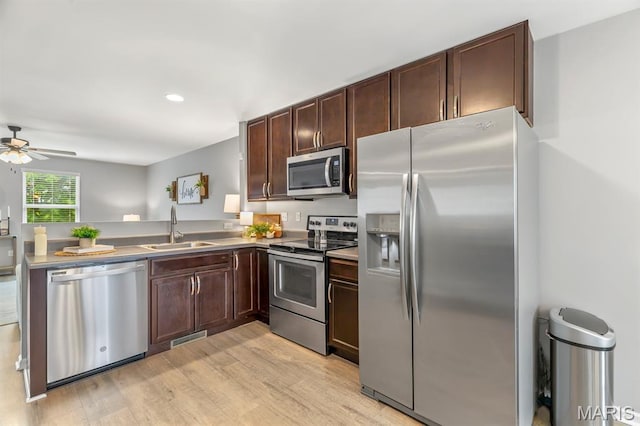 688 Rabbit Run Dr, Wentzville, MO 63385 - kitchen featuring stainless steel appliances, light wood finished floors, dark brown cabinetry, a ceiling fan, and a peninsula