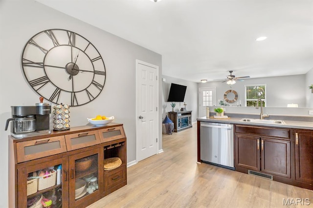 688 Rabbit Run Dr, Wentzville, MO 63385 - kitchen featuring dishwasher, light wood-type flooring, ceiling fan, dark brown cabinetry, and a fireplace
