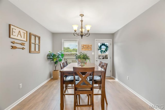 688 Rabbit Run Dr, Wentzville, MO 63385 - dining space with a chandelier and light wood-type flooring