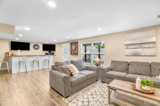 688 Rabbit Run Dr, Wentzville, MO 63385 - living room with wood finished floors, recessed lighting, and bar area