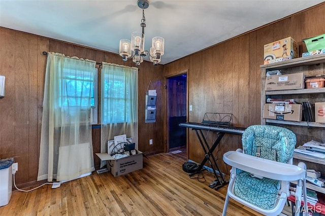 304 Warren St, Richland, MO 65556 - home office featuring a chandelier, wood walls, and wood finished floors