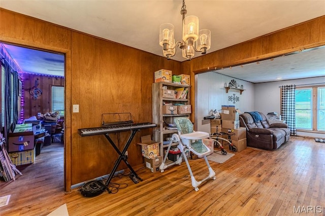 304 Warren St, Richland, MO 65556 - sitting room with hardwood / wood-style floors, a chandelier, and wood walls
