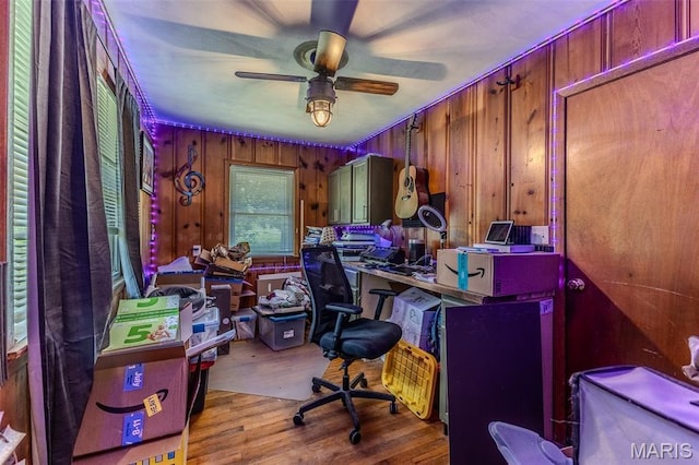 304 Warren St, Richland, MO 65556 - home office with ceiling fan, wood finished floors, and wood walls