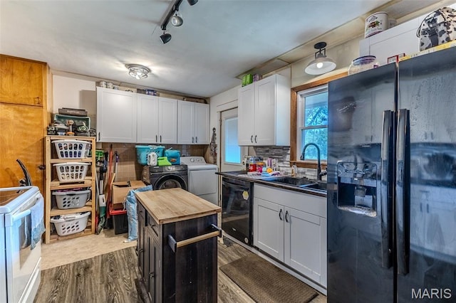 304 Warren St, Richland, MO 65556 - kitchen with black appliances, separate washer and dryer, dark wood finished floors, tasteful backsplash, and wood counters
