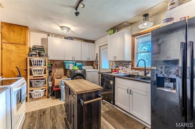 304 Warren St, Richland, MO 65556 - kitchen with black appliances, washing machine and clothes dryer, dark wood-style flooring, backsplash, and white cabinets