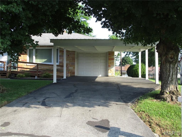 103 Paulette St, Chester, IL 62233 - view of front of house with a garage, asphalt driveway, stone siding, and a carport