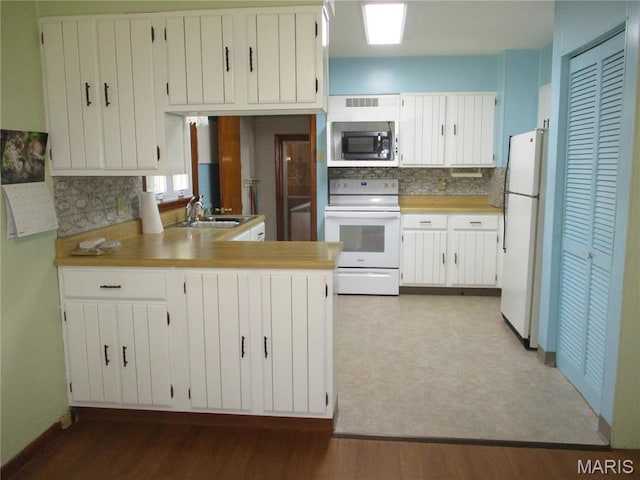 103 Paulette St, Chester, IL 62233 - kitchen featuring white appliances, tasteful backsplash, wood finished floors, light countertops, and a peninsula