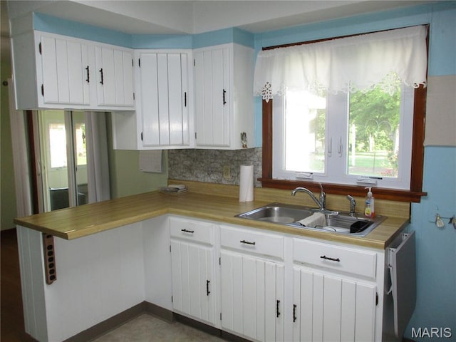 103 Paulette St, Chester, IL 62233 - kitchen with decorative backsplash, white cabinetry, light countertops, and a peninsula