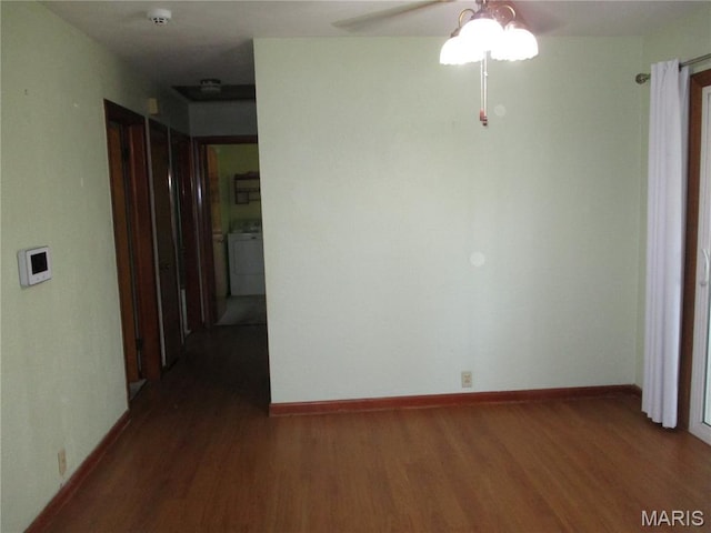 103 Paulette St, Chester, IL 62233 - spare room with washer / dryer, wood finished floors, a smoke detector, and ceiling fan