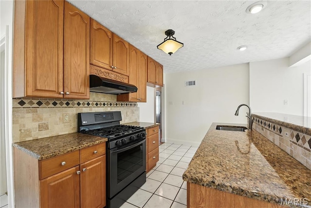 429 Belvedere Ln, Glendale, MO 63122 - kitchen with black gas stove, ventilation hood, a textured ceiling, light tile patterned floors, and decorative backsplash