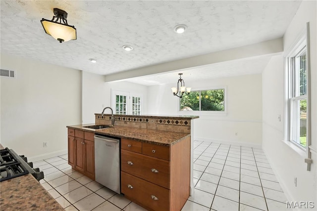 429 Belvedere Ln, Glendale, MO 63122 - kitchen featuring dishwasher, light tile patterned floors, brown cabinets, plenty of natural light, and a textured ceiling