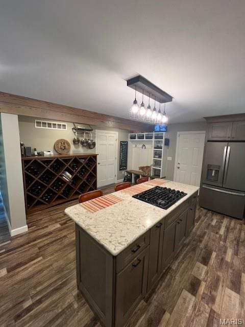 1333 Poor Farm Hollow Rd, Hardin, IL 62047 - kitchen with stainless steel fridge with ice dispenser, black gas cooktop, dark wood-type flooring, a kitchen island, and light stone countertops