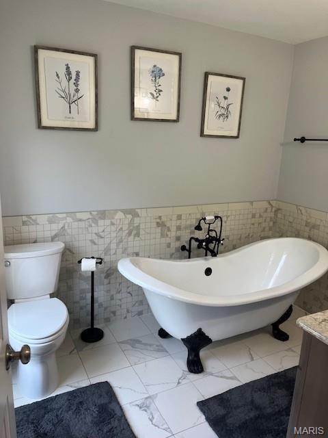 1333 Poor Farm Hollow Rd, Hardin, IL 62047 - full bathroom with tile walls, a freestanding bath, a wainscoted wall, vanity, and marble look tile flooring