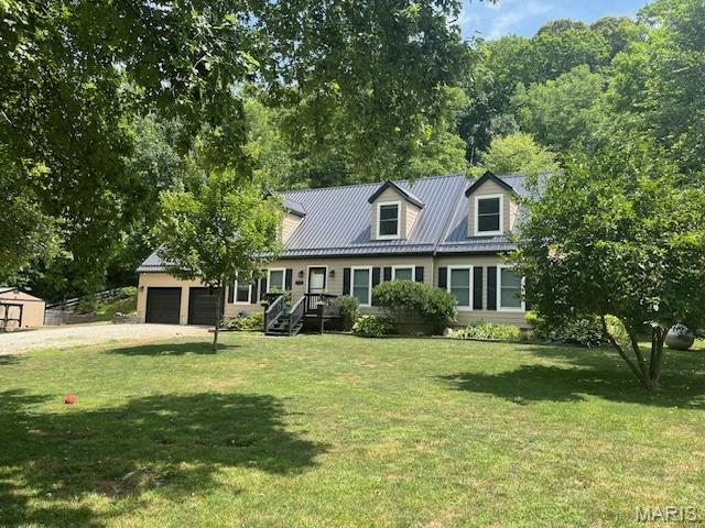 1333 Poor Farm Hollow Rd, Hardin, IL 62047 - view of front facade with driveway, a front yard, an attached garage, and a metal roof