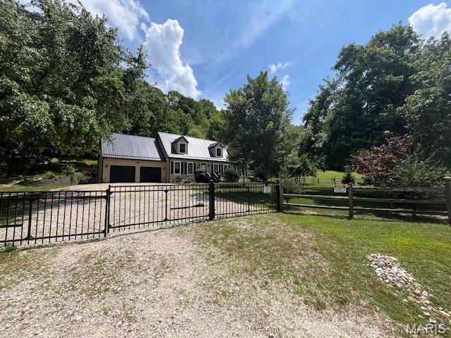 1333 Poor Farm Hollow Rd, Hardin, IL 62047 - view of front of home featuring a garage, driveway, and a metal roof