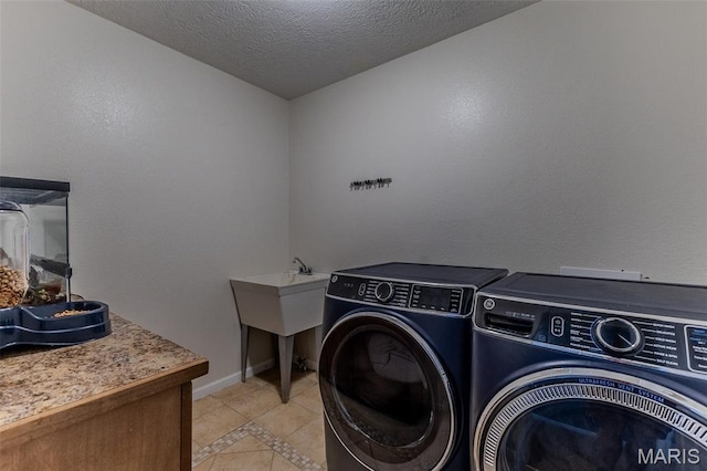 143 Lyle Curtis Cir, Waynesville, MO 65583 - laundry room featuring washing machine and dryer, inlaid floor details, light tile patterned floors, and a textured ceiling