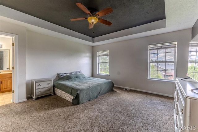 143 Lyle Curtis Cir, Waynesville, MO 65583 - bedroom featuring a raised ceiling, carpet, ensuite bath, and a ceiling fan