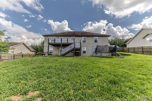 143 Lyle Curtis Cir, Waynesville, MO 65583 - back of house featuring stairway, a trampoline, a wooden deck, and a fenced backyard