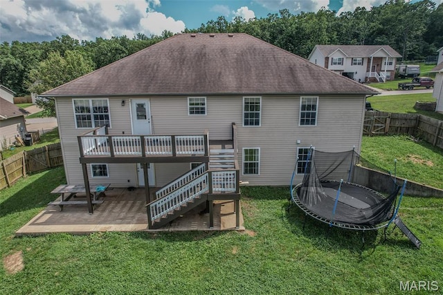 143 Lyle Curtis Cir, Waynesville, MO 65583 - rear view of house with a trampoline, a patio area, a deck, stairway, and a fenced backyard