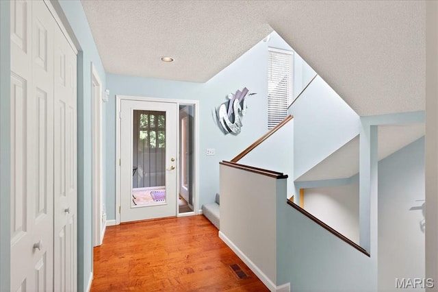 2 Tanewood Ct, Belleville, IL 62223 - foyer featuring wood finished floors, a textured ceiling, recessed lighting, and stairway