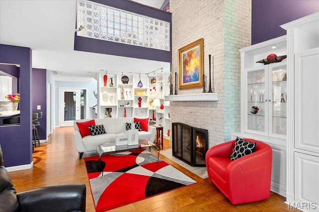2 Tanewood Ct, Belleville, IL 62223 - living room featuring wood finished floors, a brick fireplace, and a high ceiling