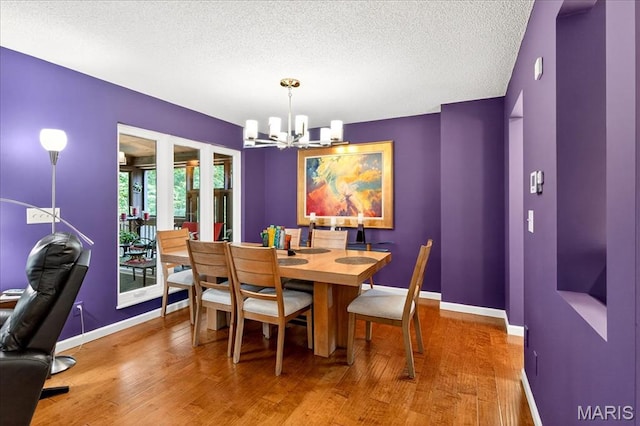 2 Tanewood Ct, Belleville, IL 62223 - dining room with a chandelier, wood finished floors, and a textured ceiling