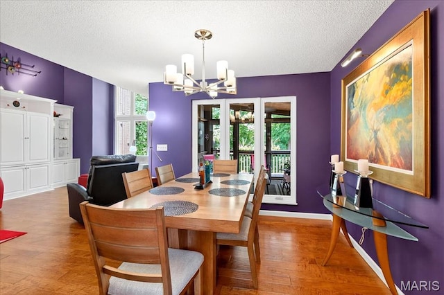 2 Tanewood Ct, Belleville, IL 62223 - dining area featuring wood finished floors, a chandelier, and a textured ceiling