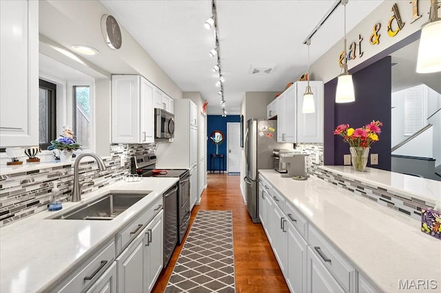 2 Tanewood Ct, Belleville, IL 62223 - kitchen with stainless steel appliances, white cabinets, tasteful backsplash, track lighting, and light countertops
