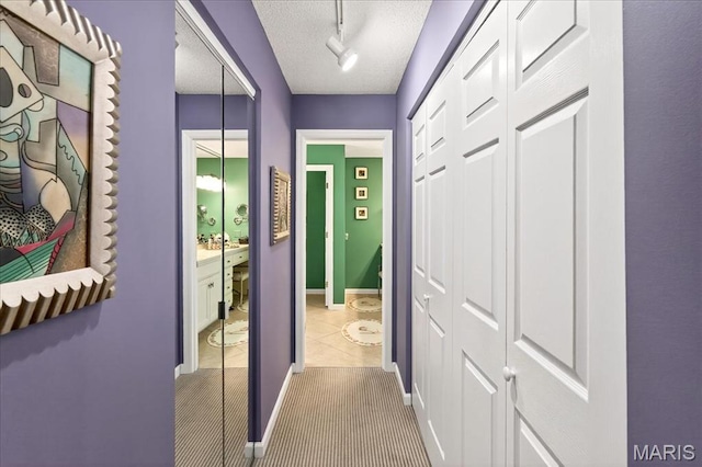 2 Tanewood Ct, Belleville, IL 62223 - hall featuring a textured ceiling, tile patterned floors, and track lighting