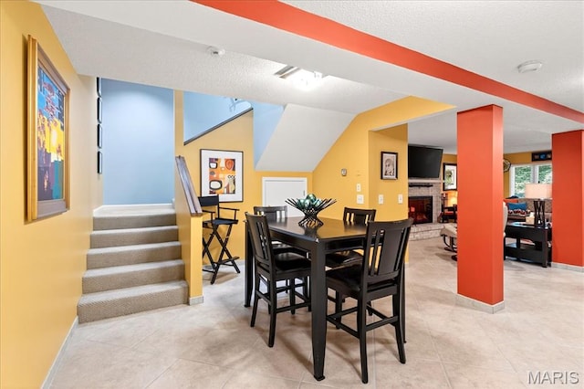 2 Tanewood Ct, Belleville, IL 62223 - dining space with a fireplace, stairs, and light tile patterned floors