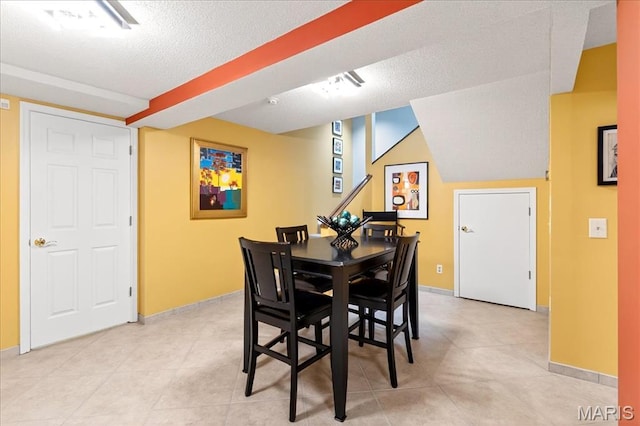 2 Tanewood Ct, Belleville, IL 62223 - dining area featuring a textured ceiling and light tile patterned floors