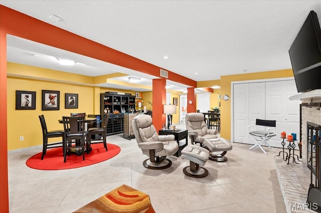 2 Tanewood Ct, Belleville, IL 62223 - living area with a dry bar, a fireplace, and tile patterned flooring