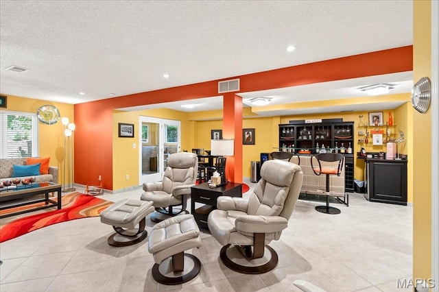 2 Tanewood Ct, Belleville, IL 62223 - tiled living room with a dry bar, a textured ceiling, and recessed lighting