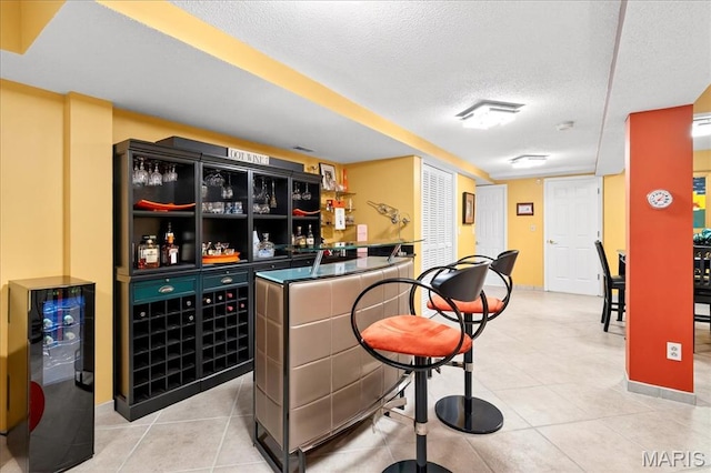 2 Tanewood Ct, Belleville, IL 62223 - indoor dry bar featuring a textured ceiling and light tile patterned floors