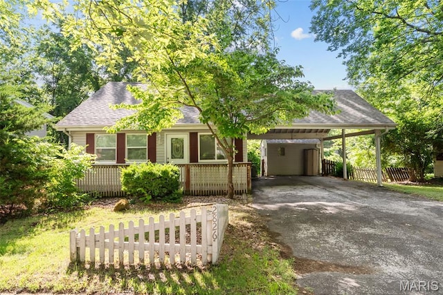 2826 Dawnview Dr, Florissant, MO 63031 - view of front of house with driveway, a shingled roof, a porch, and a carport
