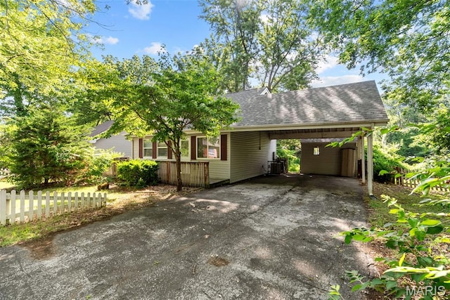 2826 Dawnview Dr, Florissant, MO 63031 - view of front of home with a shingled roof, driveway, and a carport